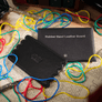 Rubber Band Leather Board by TCC Presents